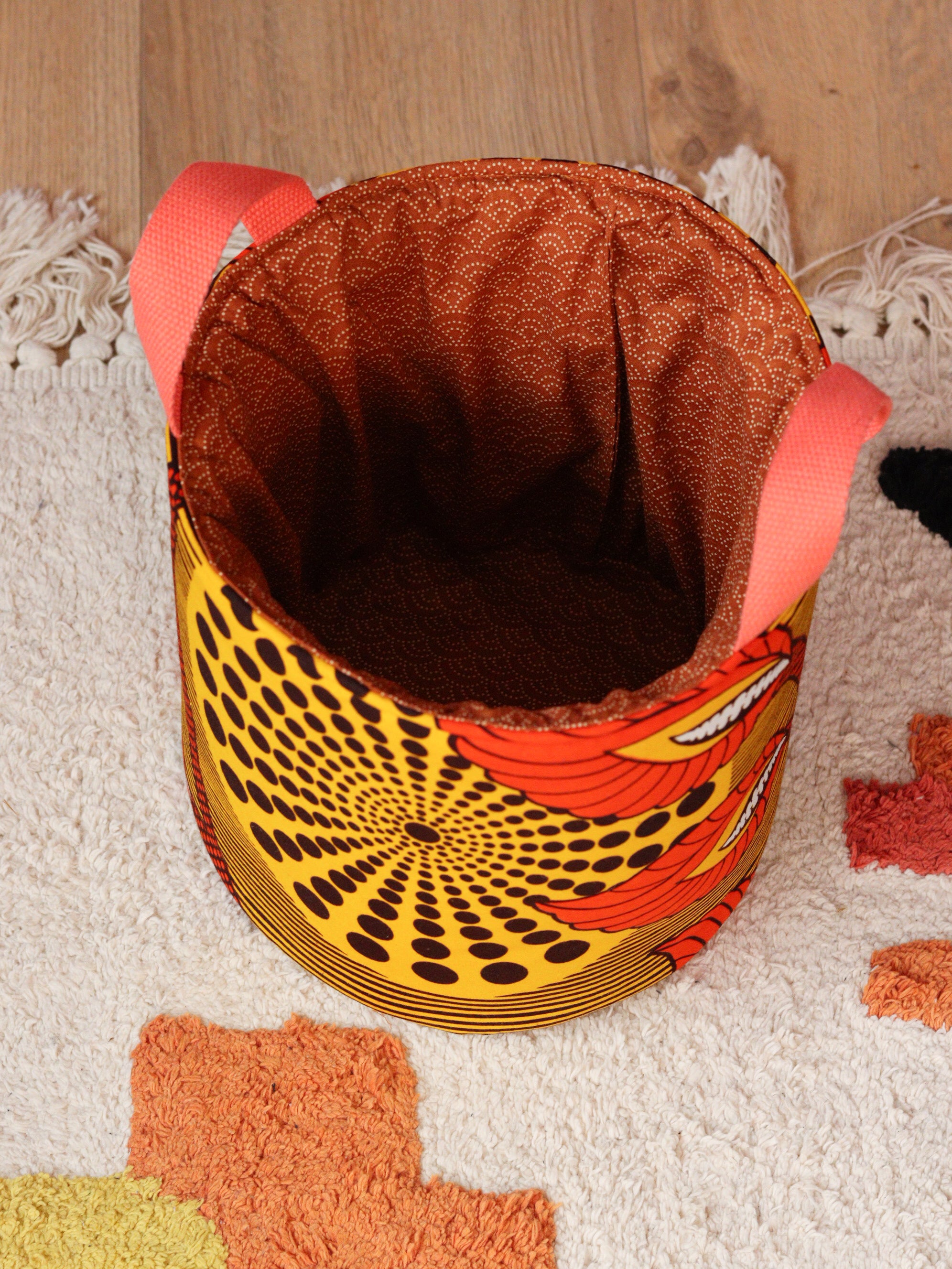 Panier rangement wax africain Strelitzia M posé dans un intérieur coloré