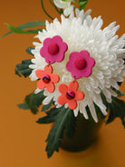 Boucles d’oreilles deux fleurs en cuir rose, orange et tissu wax, fabrication artisanale, pièce unique